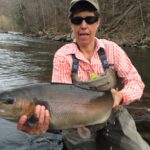 an angler holding up a large fish