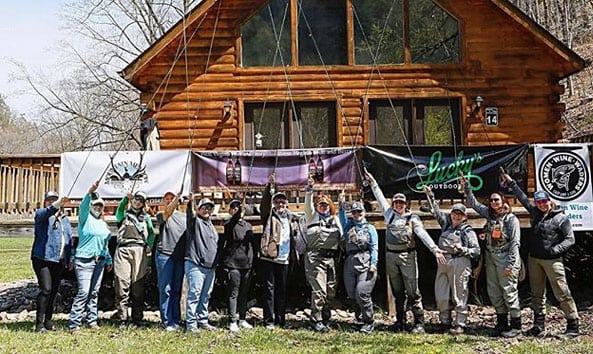 group of anglers in front of a cabin at Harman's