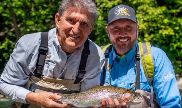 senator joe manchin holding a trout